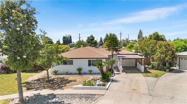 4561 N Price Ave, Fresno, CA 93726 - single story home featuring concrete driveway, a garage, and a carport