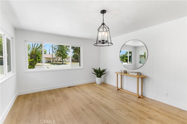 4561 N Price Ave, Fresno, CA 93726 - spare room with plenty of natural light, a chandelier, and light wood-type flooring
