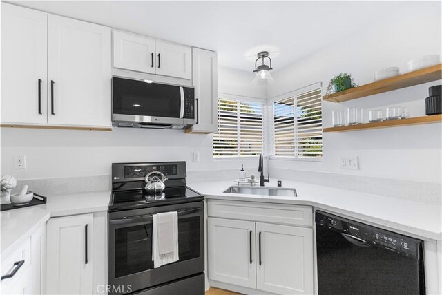 4561 N Price Ave, Fresno, CA 93726 - kitchen with stainless steel microwave, electric range, a sink, dishwasher, and white cabinetry