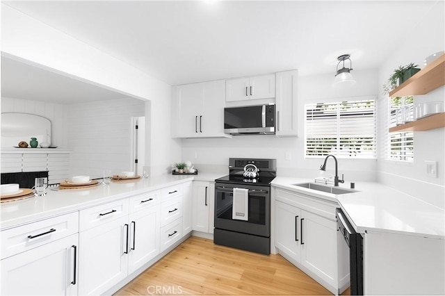 4561 N Price Ave, Fresno, CA 93726 - kitchen featuring stainless steel microwave, black electric range, a sink, open shelves, and white cabinets
