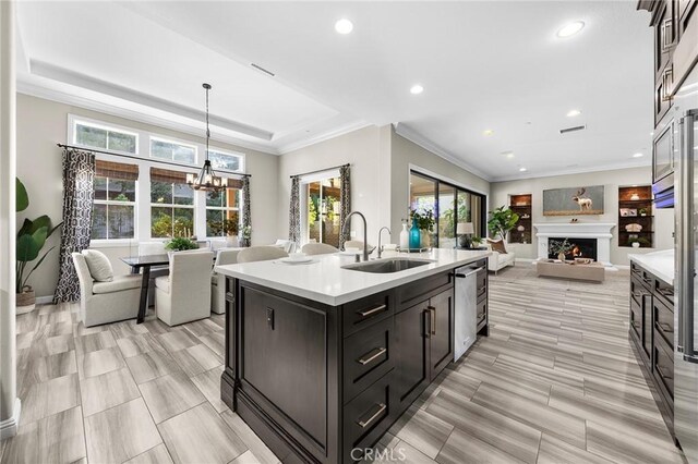 11 Goldenrod, Lake Forest, CA 92630 - kitchen with a chandelier, open floor plan, light countertops, a sink, and an island with sink