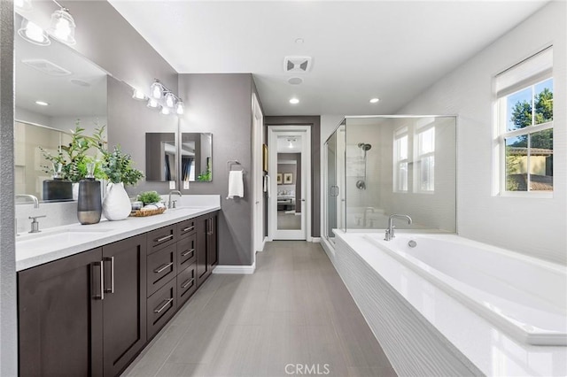 11 Goldenrod, Lake Forest, CA 92630 - full bathroom featuring a bath, double vanity, a stall shower, baseboards, and recessed lighting