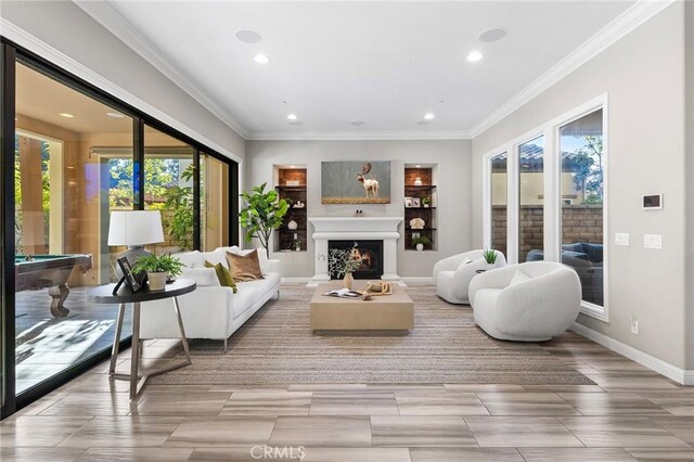 11 Goldenrod, Lake Forest, CA 92630 - living area featuring plenty of natural light, recessed lighting, a lit fireplace, billiards table, and crown molding