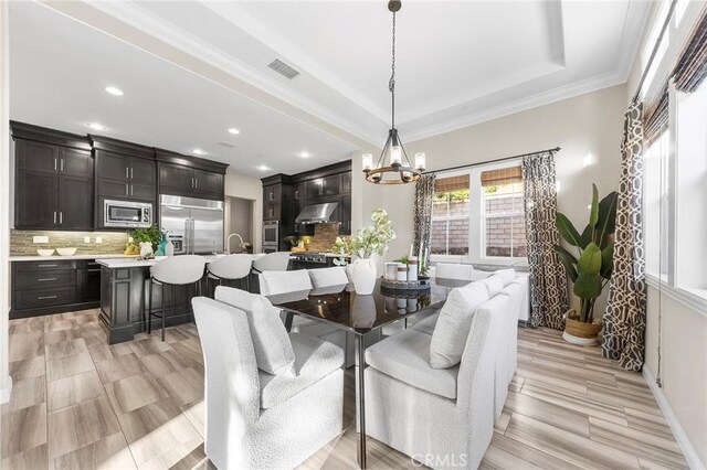 11 Goldenrod, Lake Forest, CA 92630 - dining area with a chandelier, recessed lighting, a tray ceiling, and ornamental molding
