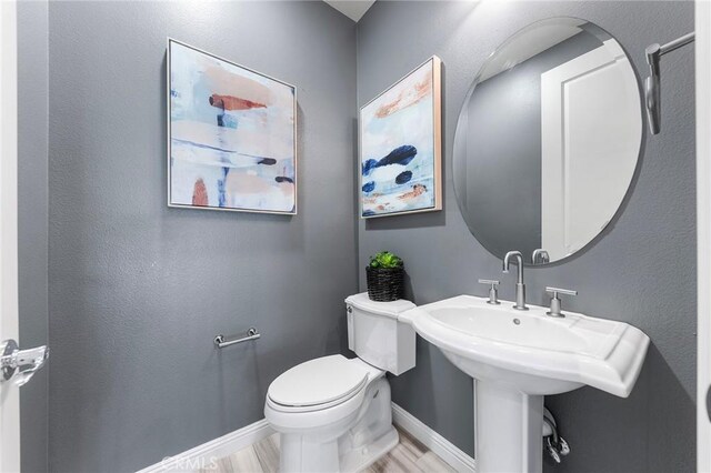 11 Goldenrod, Lake Forest, CA 92630 - bathroom with baseboards, toilet, and wood finished floors