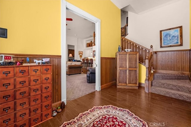 8401 Mayer Ave, Bakersfield, CA 93314 - stairs featuring a wainscoted wall, wood finished floors, and wooden walls