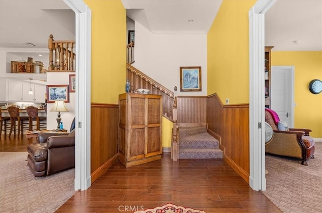 8401 Mayer Ave, Bakersfield, CA 93314 - staircase with wainscoting, wood finished floors, wooden walls, and crown molding