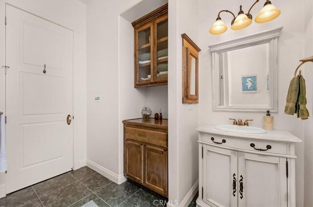 8401 Mayer Ave, Bakersfield, CA 93314 - bathroom with vanity and baseboards