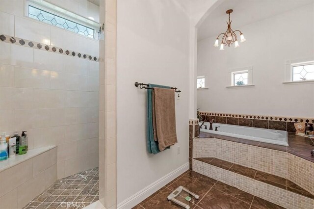 8401 Mayer Ave, Bakersfield, CA 93314 - full bath featuring a bath, a chandelier, walk in shower, and baseboards