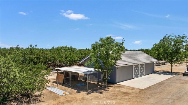 8401 Mayer Ave, Bakersfield, CA 93314 - garage featuring driveway and a view of rural / pastoral area