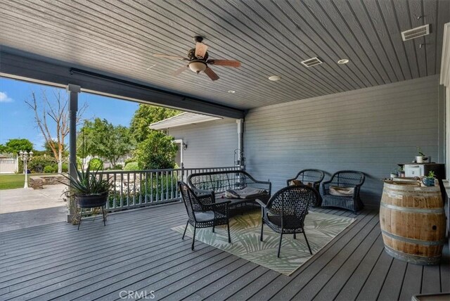 8401 Mayer Ave, Bakersfield, CA 93314 - wooden terrace with ceiling fan and an outdoor hangout area