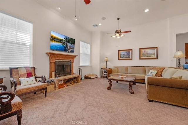 8401 Mayer Ave, Bakersfield, CA 93314 - carpeted living area featuring a ceiling fan, a fireplace with raised hearth, recessed lighting, and crown molding
