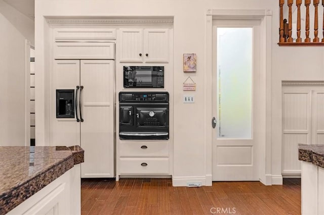 8401 Mayer Ave, Bakersfield, CA 93314 - kitchen with paneled fridge, dark wood finished floors, black microwave, and white cabinetry