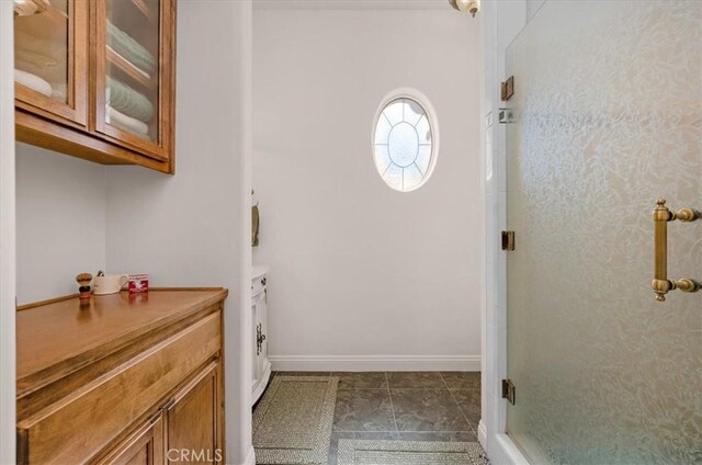 8401 Mayer Ave, Bakersfield, CA 93314 - bathroom featuring a shower stall and baseboards