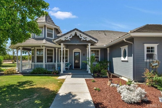 8401 Mayer Ave, Bakersfield, CA 93314 - view of front of home featuring covered porch, a front lawn, and a tile roof