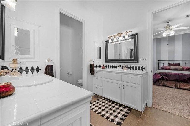 8401 Mayer Ave, Bakersfield, CA 93314 - bathroom with vanity, tile patterned floors, a ceiling fan, toilet, and connected bathroom