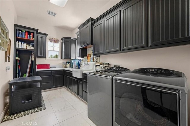 8401 Mayer Ave, Bakersfield, CA 93314 - washroom featuring independent washer and dryer, cabinet space, and light marble finish floors
