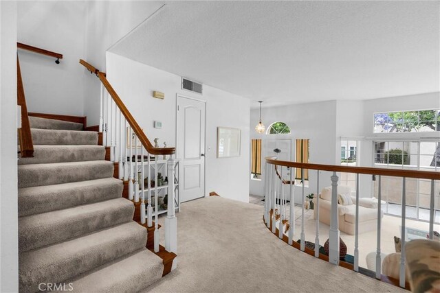 2300 Maple Ave Unit 138, Torrance, CA 90503 - stairs featuring carpet floors and a textured ceiling