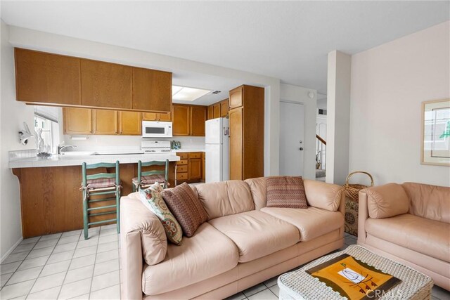 2300 Maple Ave Unit 138, Torrance, CA 90503 - living room featuring light tile patterned floors, stairway, and baseboards