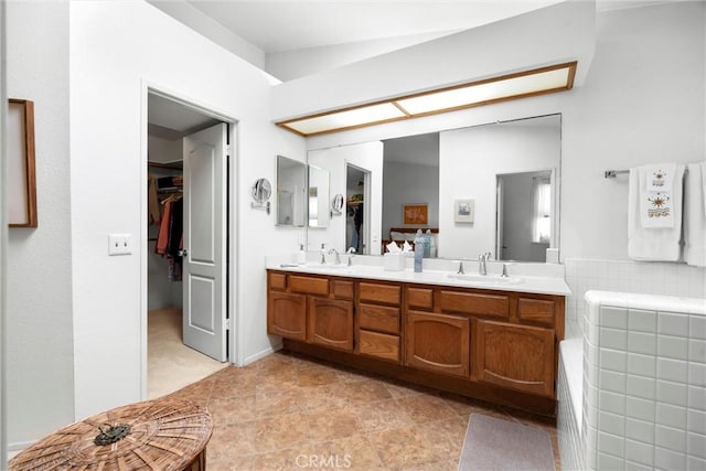 2300 Maple Ave Unit 138, Torrance, CA 90503 - full bathroom featuring double vanity, a spacious closet, and a tub
