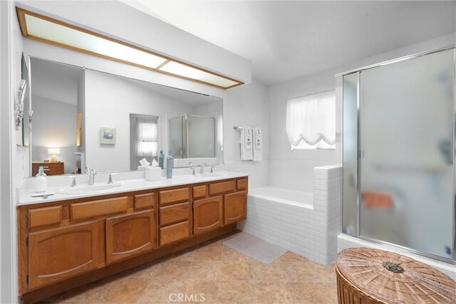 2300 Maple Ave Unit 138, Torrance, CA 90503 - full bathroom featuring a garden tub, double vanity, a shower stall, and tile patterned floors