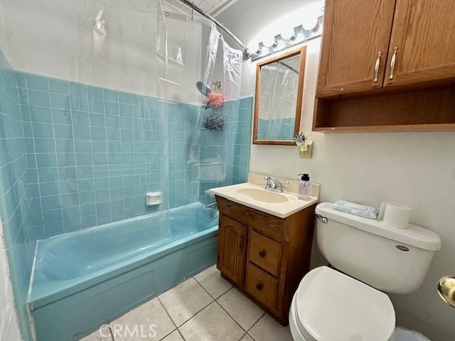 27441 Villa Ave, Highland, CA 92346 - bathroom with vanity, tile patterned floors, toilet, and shower / bathtub combination with curtain
