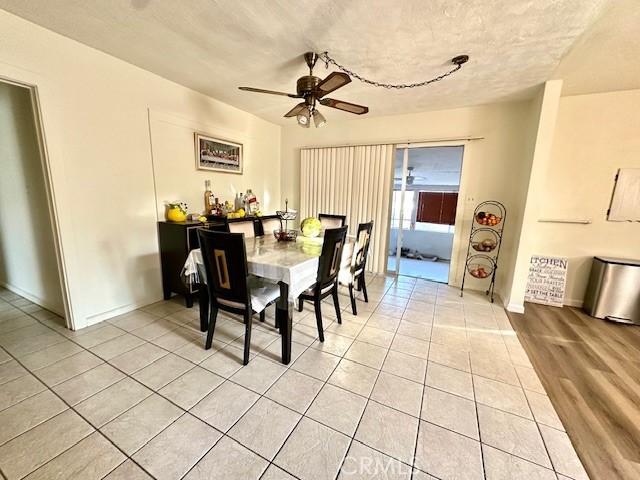 27441 Villa Ave, Highland, CA 92346 - dining room featuring light tile patterned floors, a ceiling fan, and baseboards