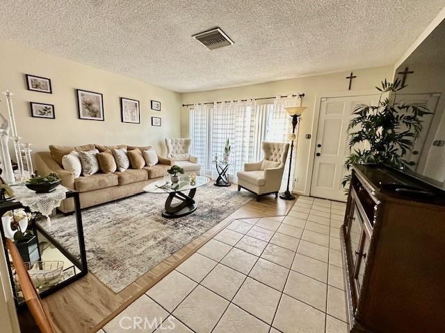 27441 Villa Ave, Highland, CA 92346 - living area featuring a textured ceiling and light tile patterned floors