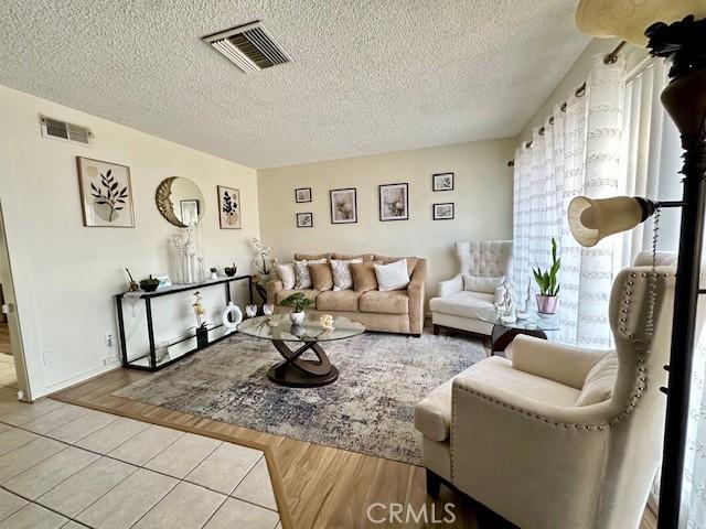 27441 Villa Ave, Highland, CA 92346 - living area with a textured ceiling and wood finished floors