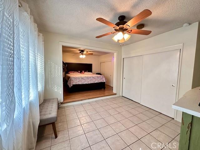 27441 Villa Ave, Highland, CA 92346 - bedroom featuring a textured ceiling, ceiling fan, and light tile patterned floors