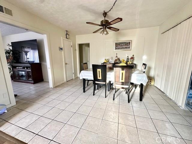 27441 Villa Ave, Highland, CA 92346 - dining space with light tile patterned floors and a ceiling fan