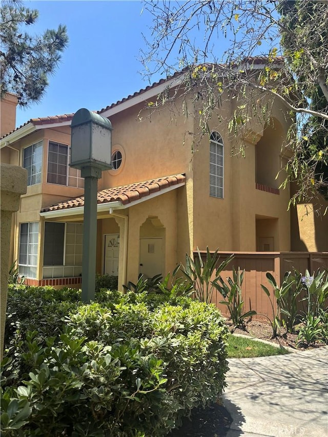 70 Costero Aisle Unit 304, Irvine, CA 92614 - view of front facade featuring stucco siding and a tiled roof