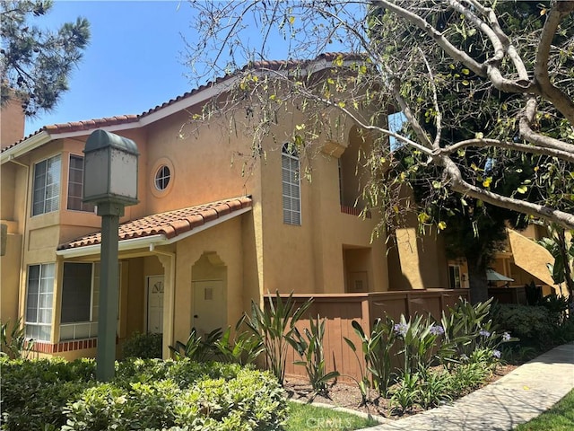 70 Costero Aisle Unit 304, Irvine, CA 92614 - view of front of house with a tiled roof and stucco siding