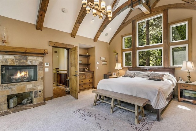 29025 Red Grouse Ct, Lake Arrowhead, CA 92352 - carpeted bedroom with a stone fireplace, beam ceiling, and high vaulted ceiling