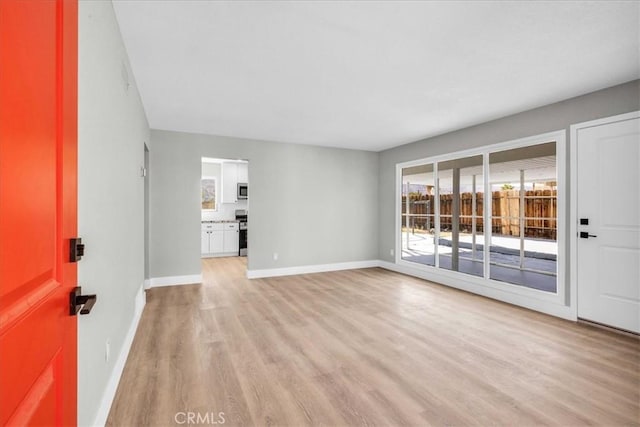 73461 El Paseo Dr Unit 29, Palms, CA 92277 - unfurnished living room with light wood-type flooring and baseboards