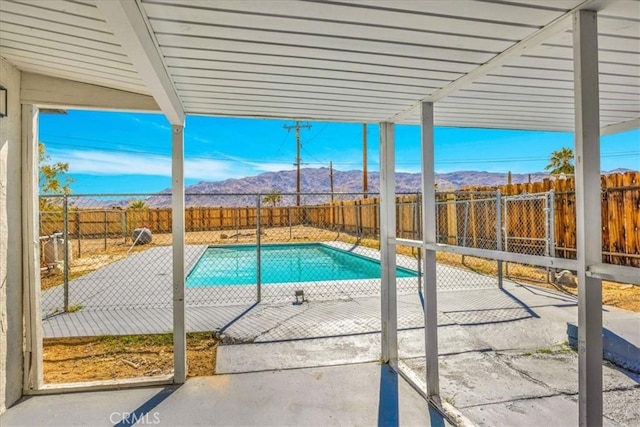 73461 El Paseo Dr Unit 29, Palms, CA 92277 - view of swimming pool with a mountain view, a patio, and a fenced backyard