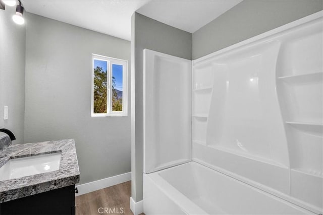 73461 El Paseo Dr Unit 29, Palms, CA 92277 - full bath featuring vanity, wood finished floors, and washtub / shower combination