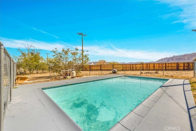 73461 El Paseo Dr Unit 29, Palms, CA 92277 - view of pool with a fenced backyard, a mountain view, and a patio area