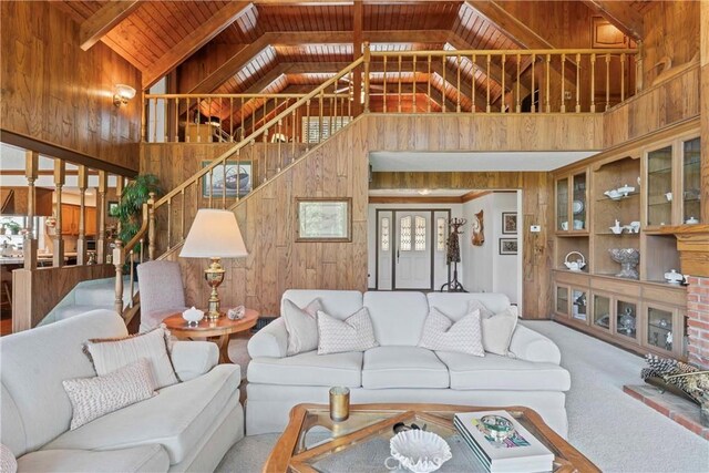 524 Golf Course Rd, Lake Arrowhead, CA 92352 - living area with wooden walls, high vaulted ceiling, stairs, carpet flooring, and wooden ceiling with exposed beams
