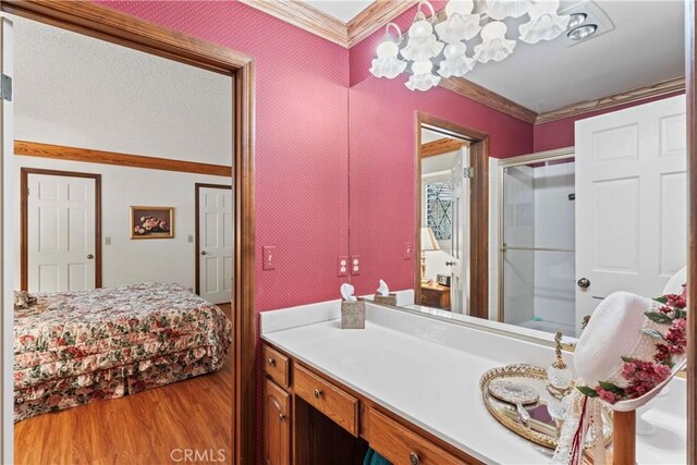 524 Golf Course Rd, Lake Arrowhead, CA 92352 - full bath featuring crown molding, wood finished floors, vanity, a chandelier, and a shower with shower door