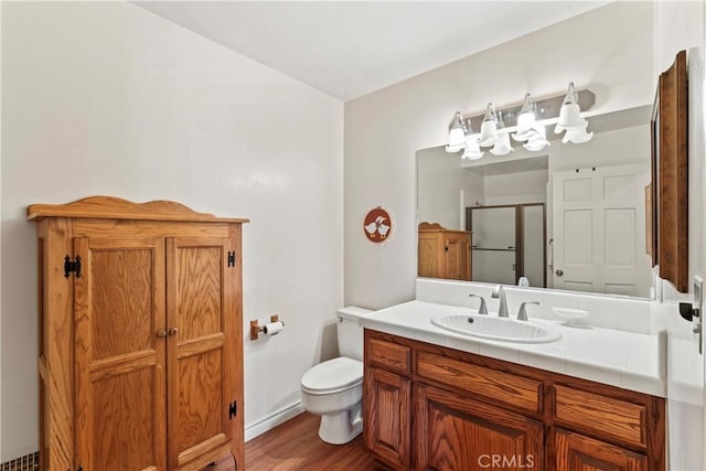 524 Golf Course Rd, Lake Arrowhead, CA 92352 - bathroom featuring vanity, a stall shower, toilet, and wood finished floors