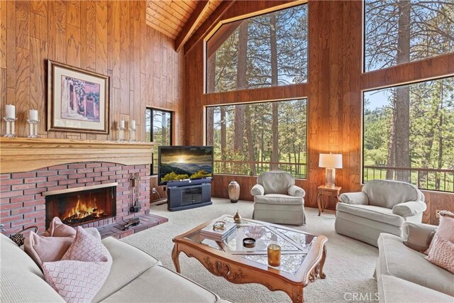 524 Golf Course Rd, Lake Arrowhead, CA 92352 - carpeted living area with high vaulted ceiling, wood walls, wooden ceiling with exposed beams, and a brick fireplace