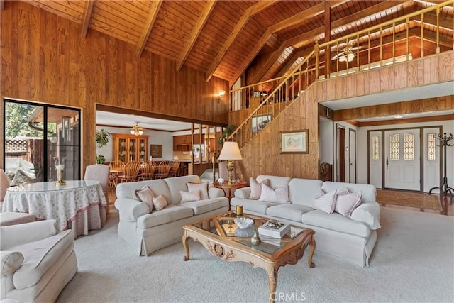 524 Golf Course Rd, Lake Arrowhead, CA 92352 - carpeted living room featuring high vaulted ceiling, wooden walls, wood ceiling with exposed beams, and stairs
