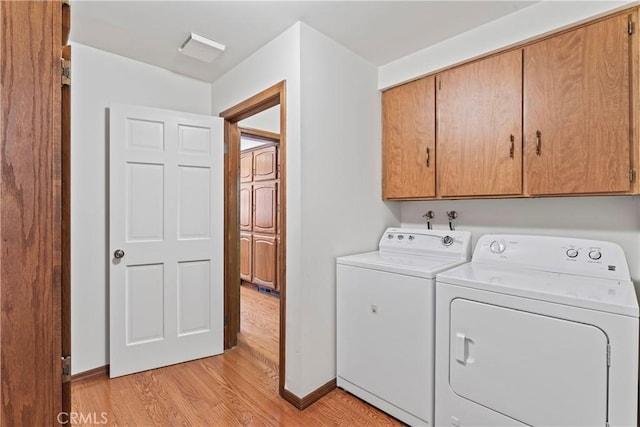 524 Golf Course Rd, Lake Arrowhead, CA 92352 - laundry room with cabinet space, washing machine and dryer, light wood-style floors, and baseboards
