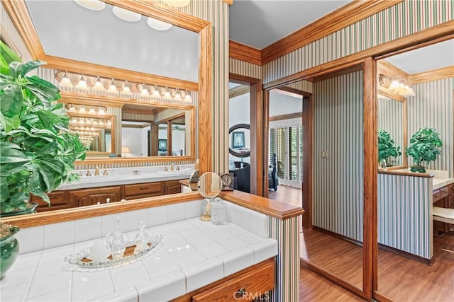 524 Golf Course Rd, Lake Arrowhead, CA 92352 - bathroom with wood finished floors, vanity, wallpapered walls, and ornamental molding