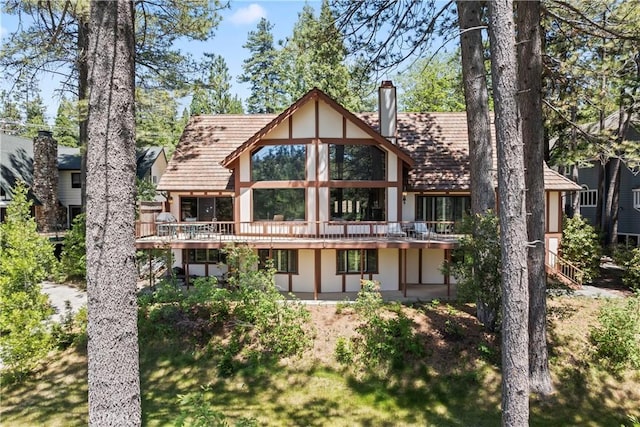 524 Golf Course Rd, Lake Arrowhead, CA 92352 - back of property with a chimney, stucco siding, and a wooden deck