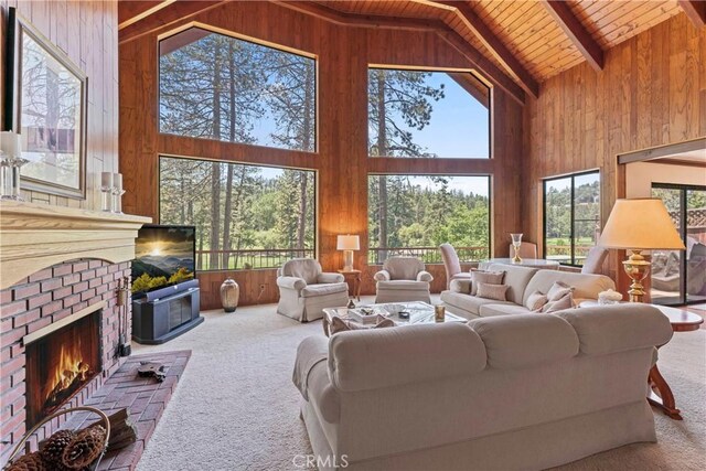 524 Golf Course Rd, Lake Arrowhead, CA 92352 - living room with wooden walls, wood ceiling with exposed beams, carpet floors, high vaulted ceiling, and a brick fireplace