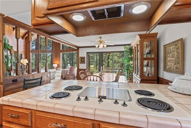 524 Golf Course Rd, Lake Arrowhead, CA 92352 - kitchen with tile counters, brown cabinetry, ceiling fan, and white electric cooktop