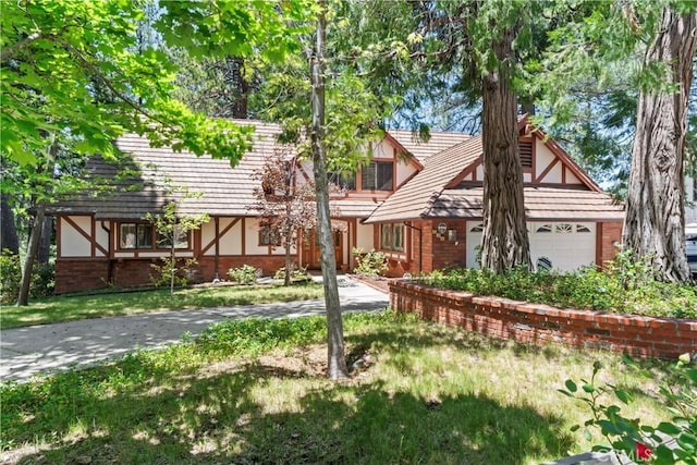 524 Golf Course Rd, Lake Arrowhead, CA 92352 - tudor home featuring brick siding, stucco siding, a garage, and a front yard