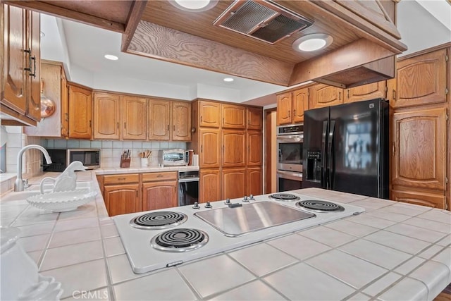 524 Golf Course Rd, Lake Arrowhead, CA 92352 - kitchen with tile countertops, appliances with stainless steel finishes, backsplash, tile patterned flooring, and recessed lighting